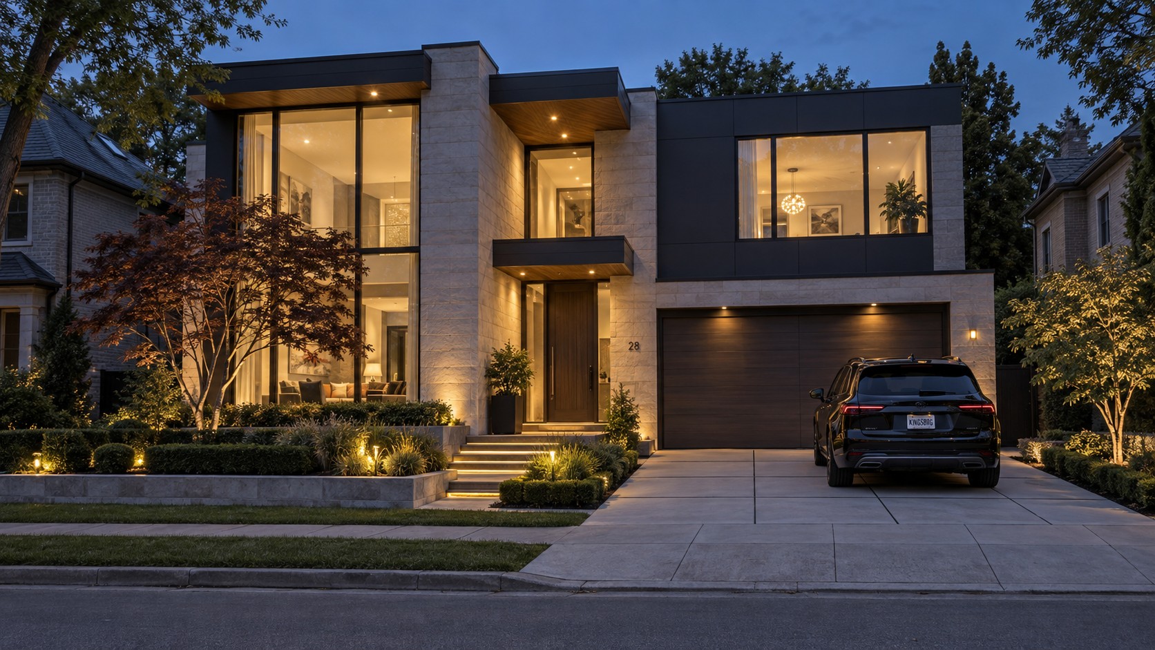 Conceptual contemporary limestone home with charcoal panels, walnut-toned soffits and warm glazing at blue hour